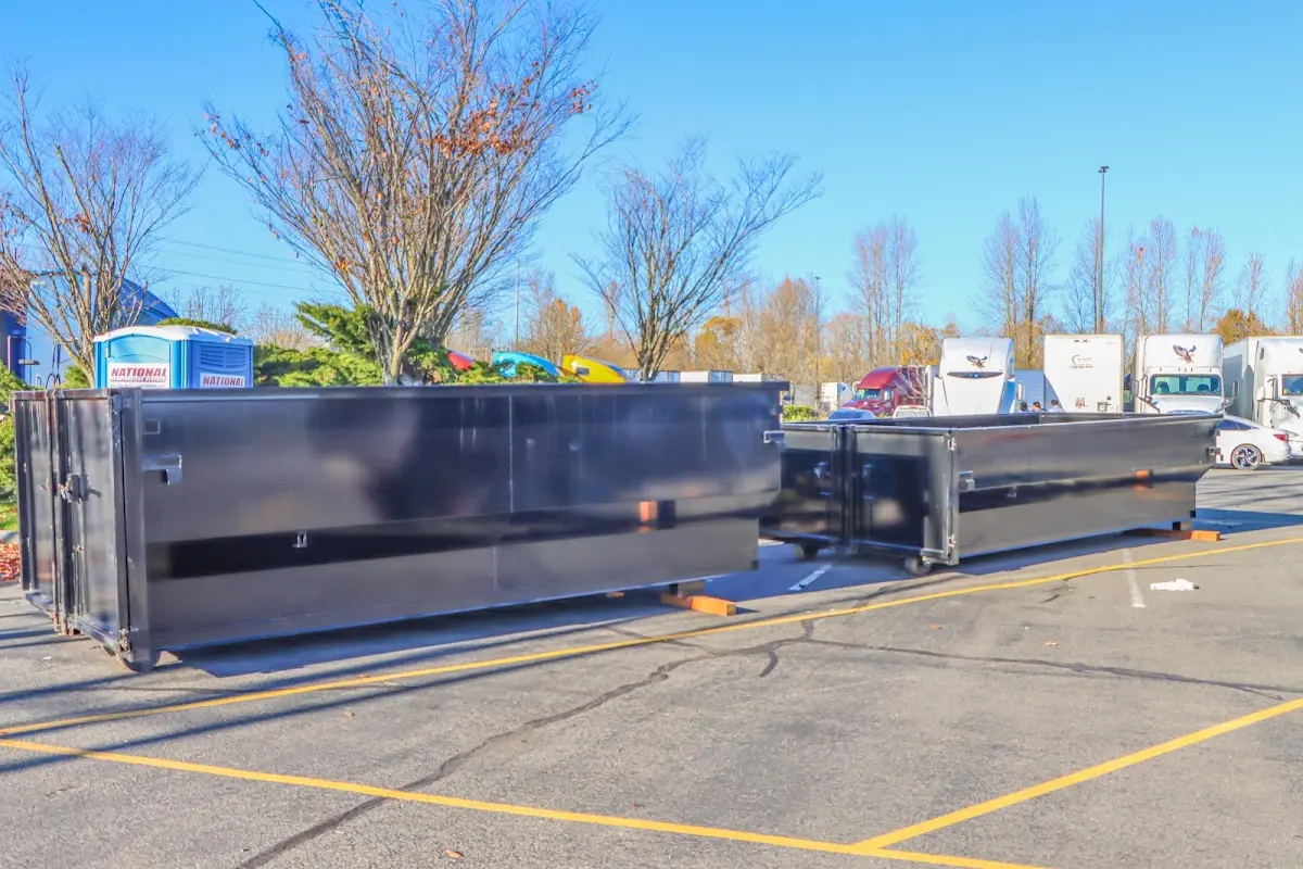 Professional dumpster rental service with roll-off container on residential driveway in Brigantine